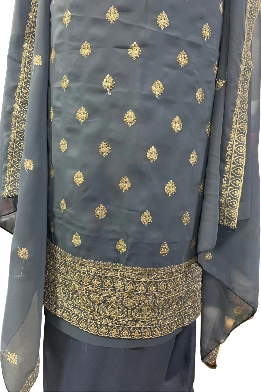 Traditional outfit with embroidered details on a plain background