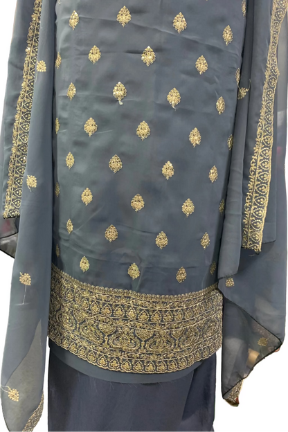 Traditional outfit with embroidered details on a plain background