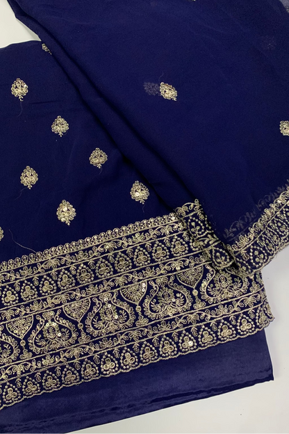 Navy blue fabric with gold embroidery on a white background