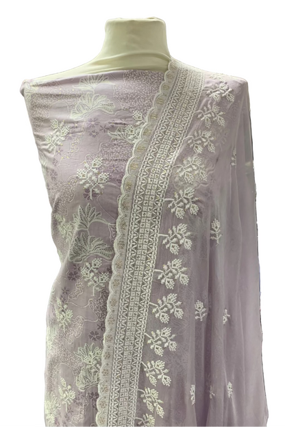 Lilac embroidered fabric on a mannequin in a store setting