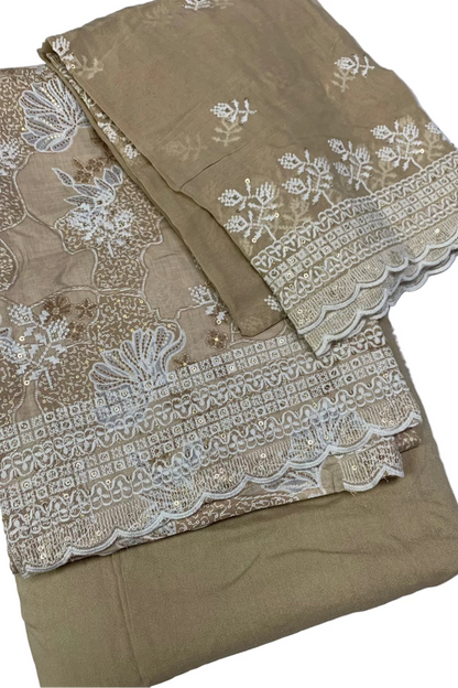 Beige fabric with white embroidery on a white background