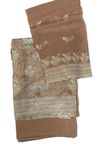 Peach fabric with intricate white lace and floral patterns on a white background