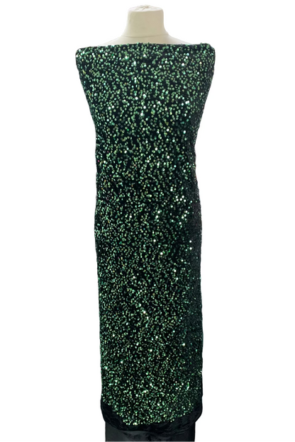 Green sequin dress on a mannequin in a fabric store