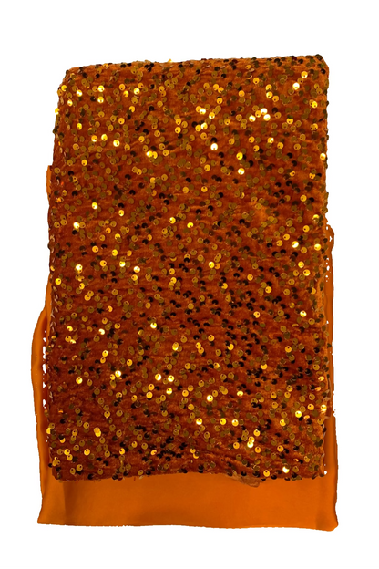 Gold sequin fabric on a white background