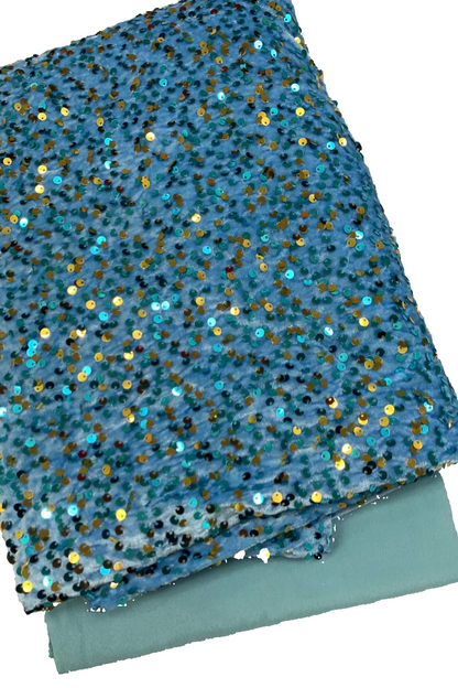 Blue fabric with gold and blue sequins on a white background
