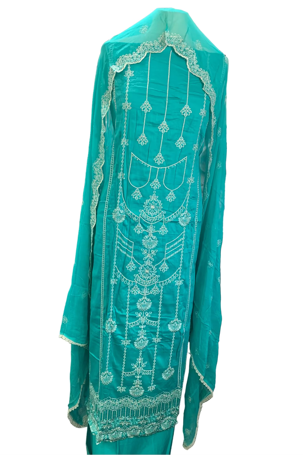 Turquoise embroidered garment in a fabric store setting