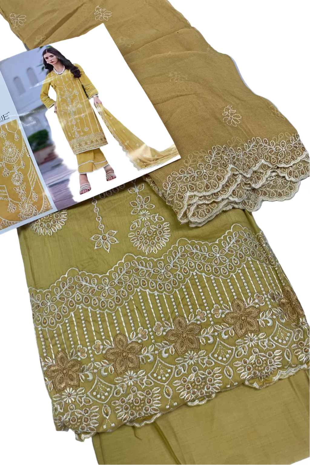 Mustard yellow embroidered fabric with a matching outfit on a white surface