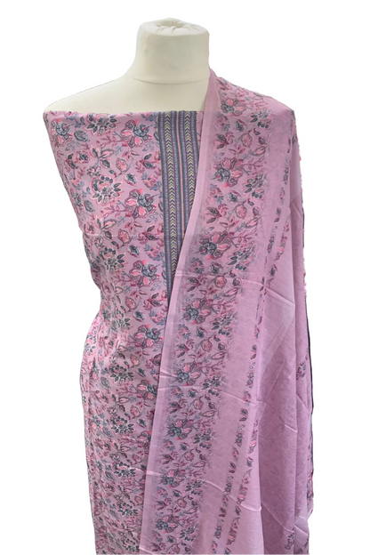 Floral-patterned fabric draped over a mannequin in a fabric store.