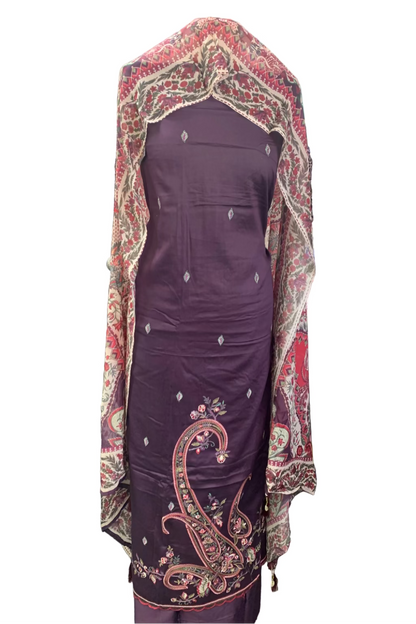 Purple traditional outfit with a patterned shawl in a fabric store setting