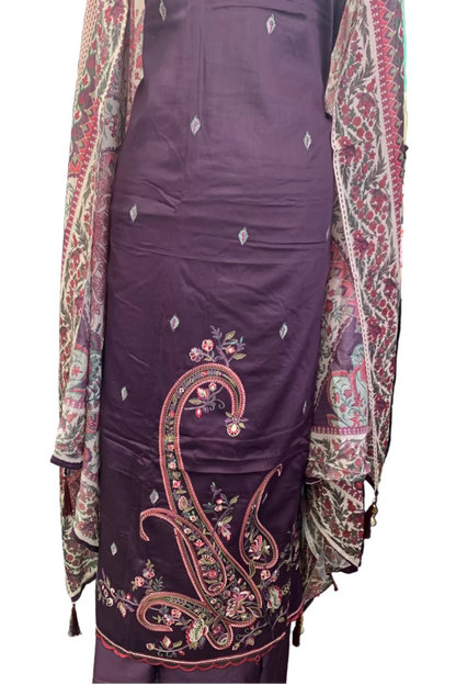 Purple embroidered outfit with a patterned jacket in a fabric store setting