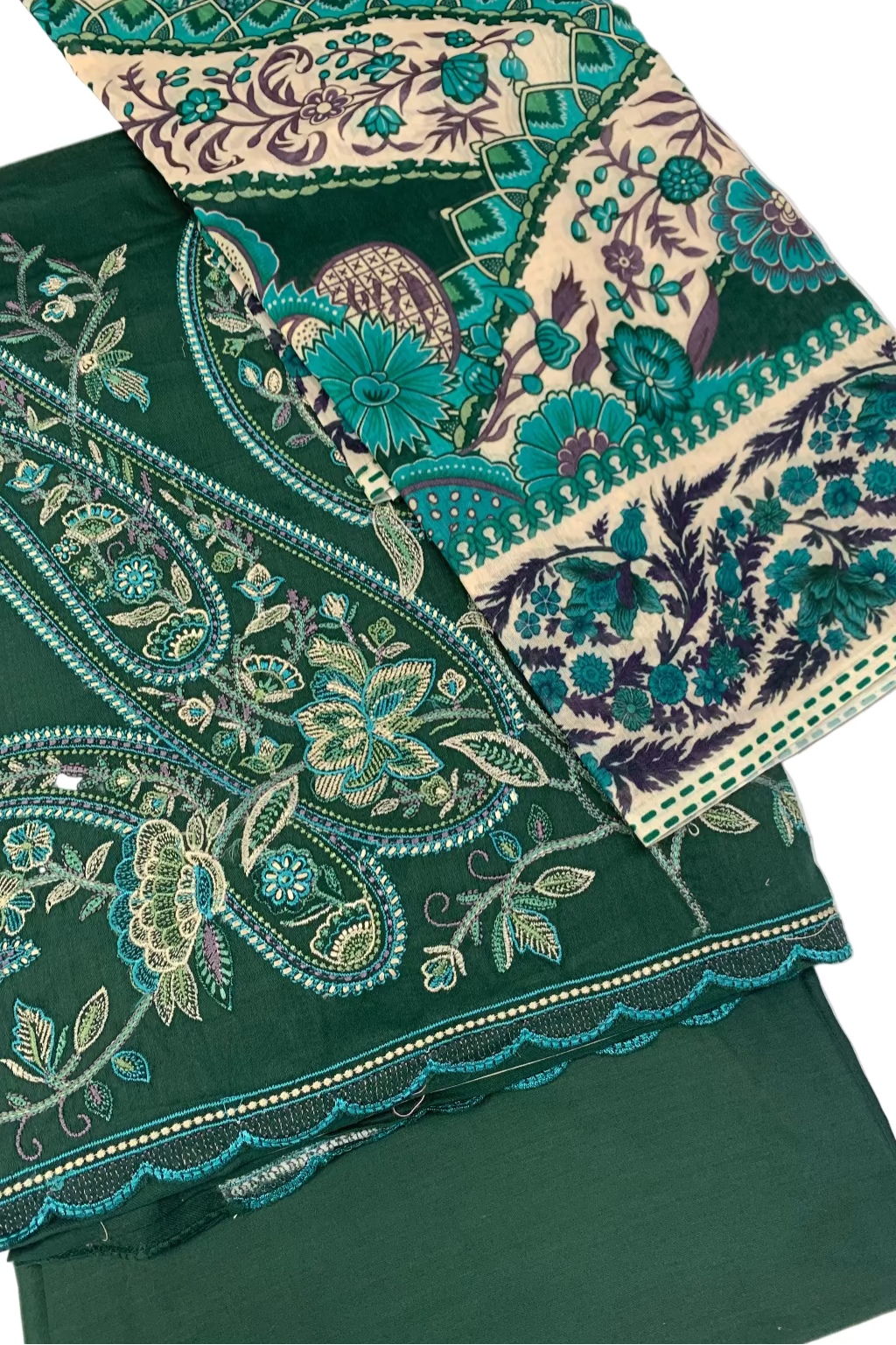 Green fabric with intricate floral embroidery on a white background