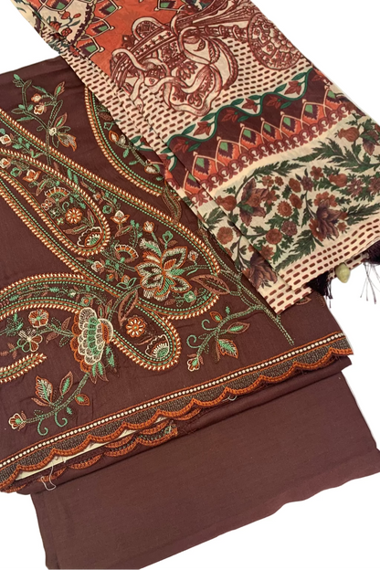 Brown fabric with intricate paisley patterns on a white background