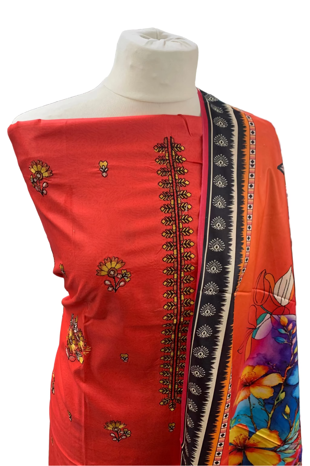 Red dress with intricate patterns on a mannequin in a store setting.