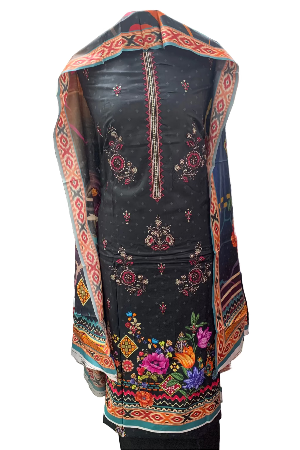 Traditional embroidered garment in a store setting with fabric and clothing in the background