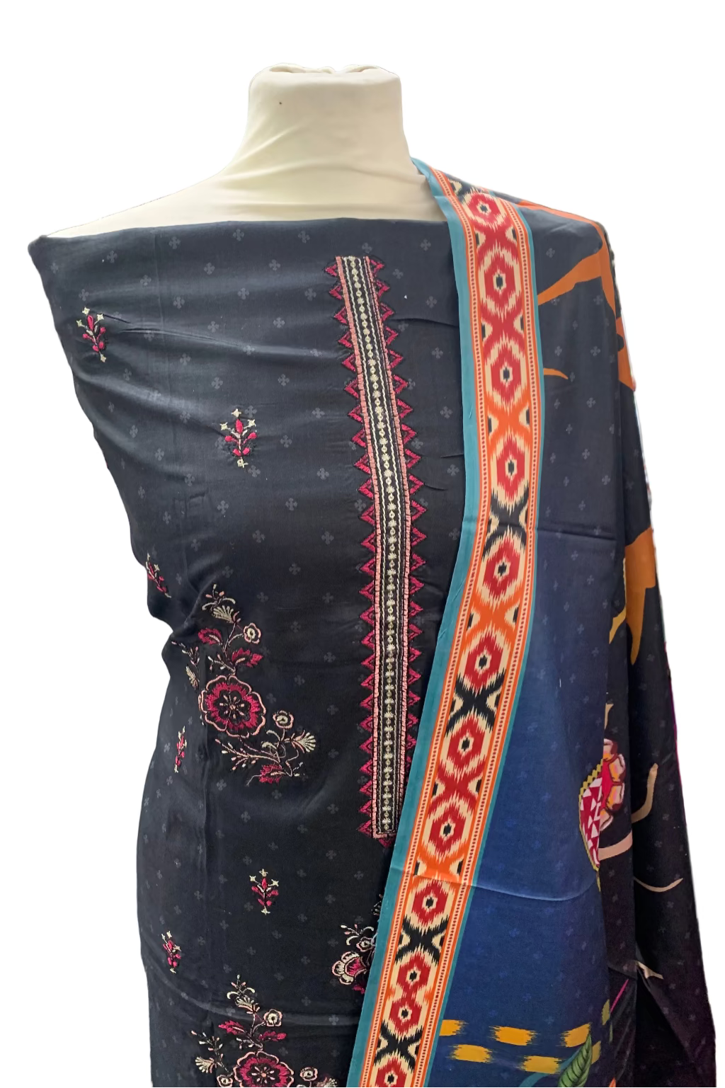 Black embroidered saree with colorful patterns on a mannequin in a store setting.