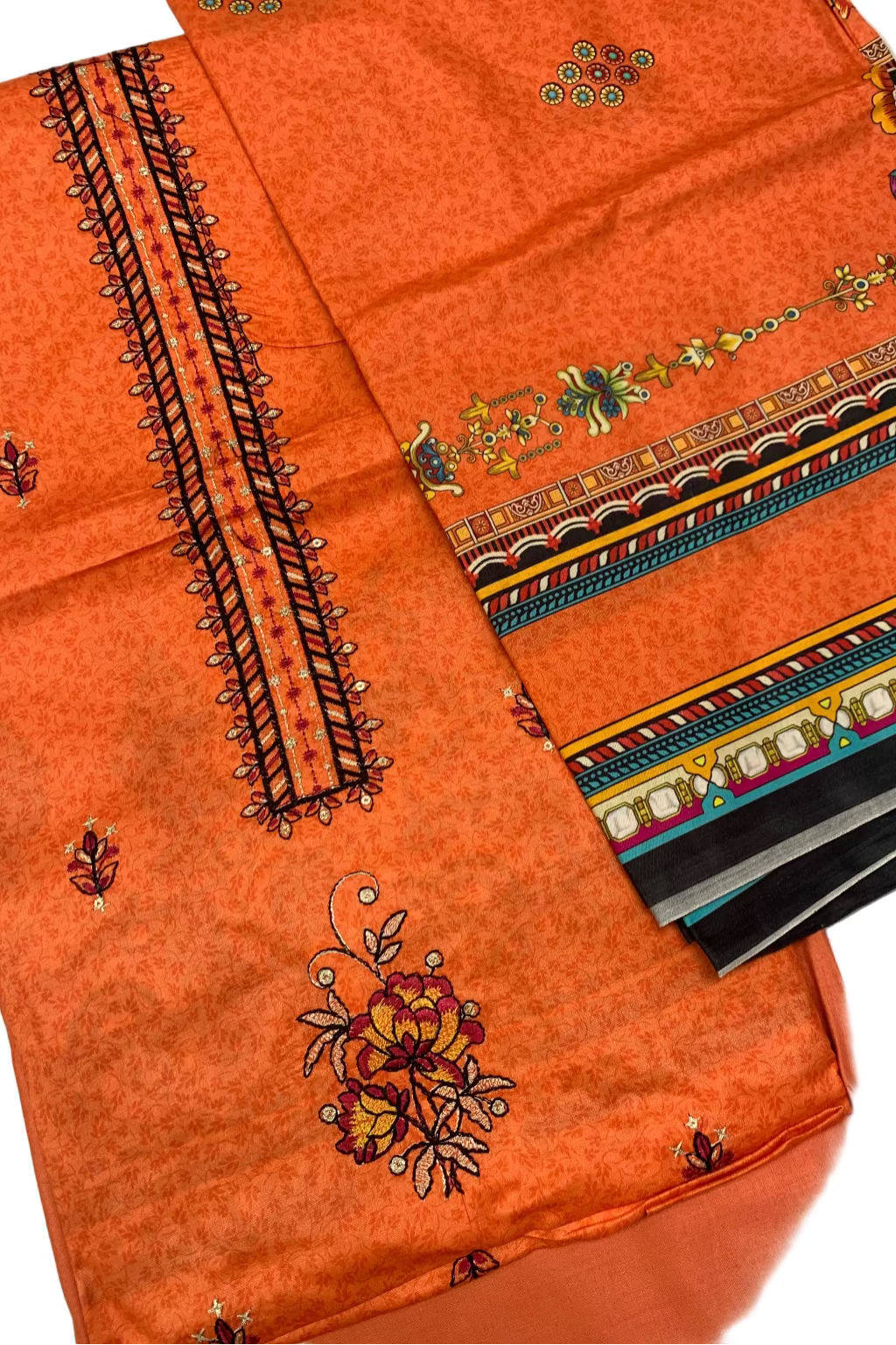 Orange fabric with intricate embroidery on a white background
