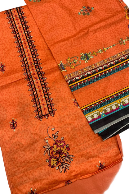 Orange fabric with intricate embroidery on a white background
