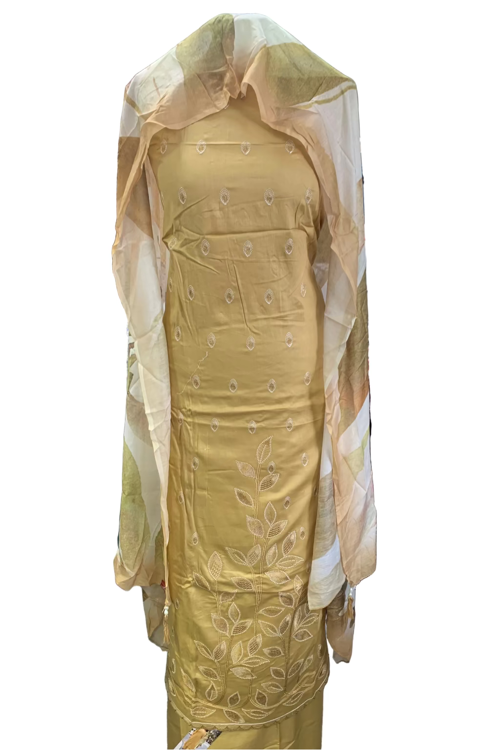 Gold embroidered dress on a mannequin in a store setting with fabric rolls in the background