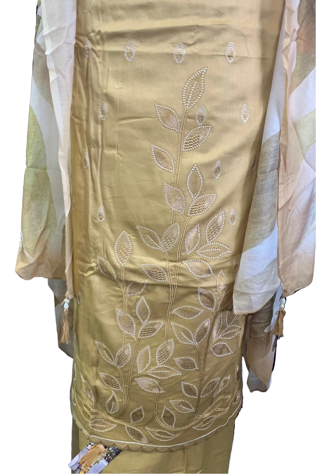 Gold embroidered garment on a stand with a white background