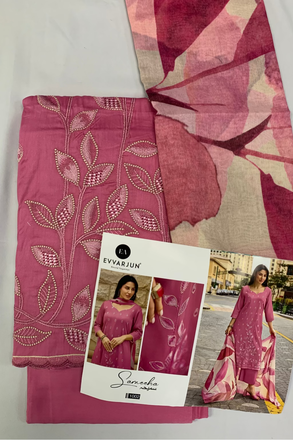 Pink embroidered fabric with a packaging card featuring a model wearing the fabric.