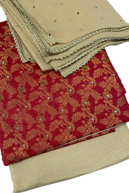 Stack of fabric samples including red and gold patterned fabric and beige fabric with embellishments on a white background