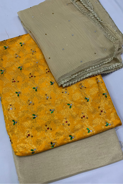 Two pieces of fabric, one yellow with green patterns and one beige, on a white background.