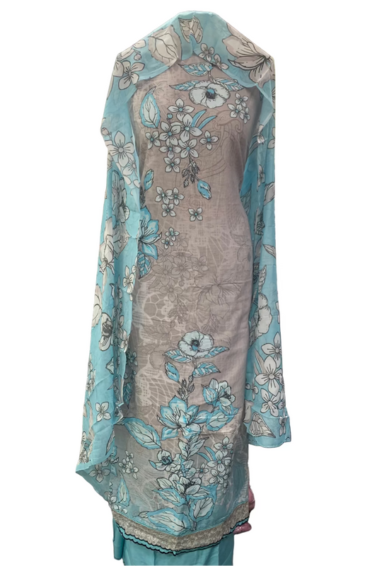 Gray dress with floral patterns draped over a mannequin in a fabric store.