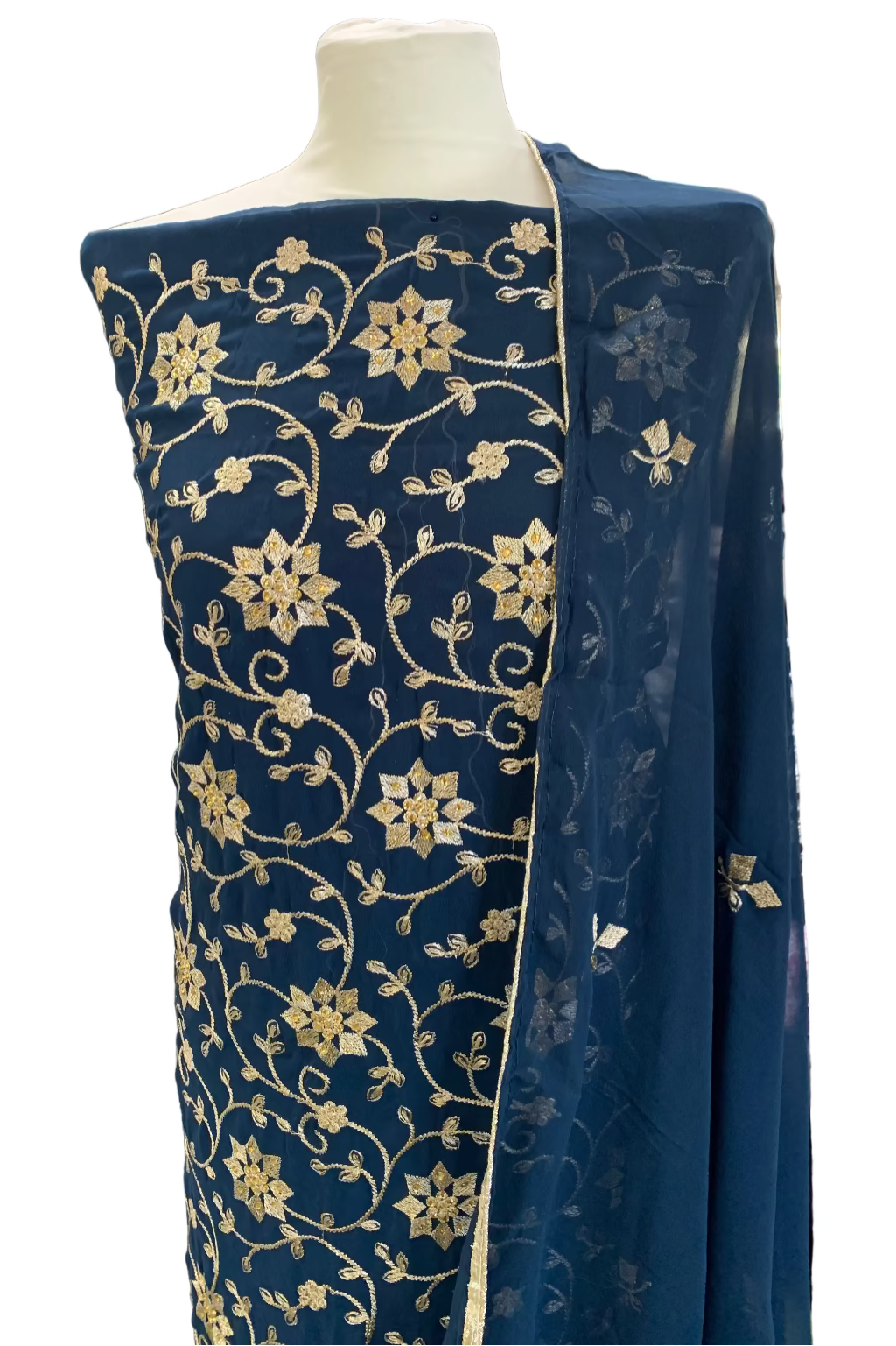 Navy blue fabric with gold floral patterns on a mannequin in a store setting.