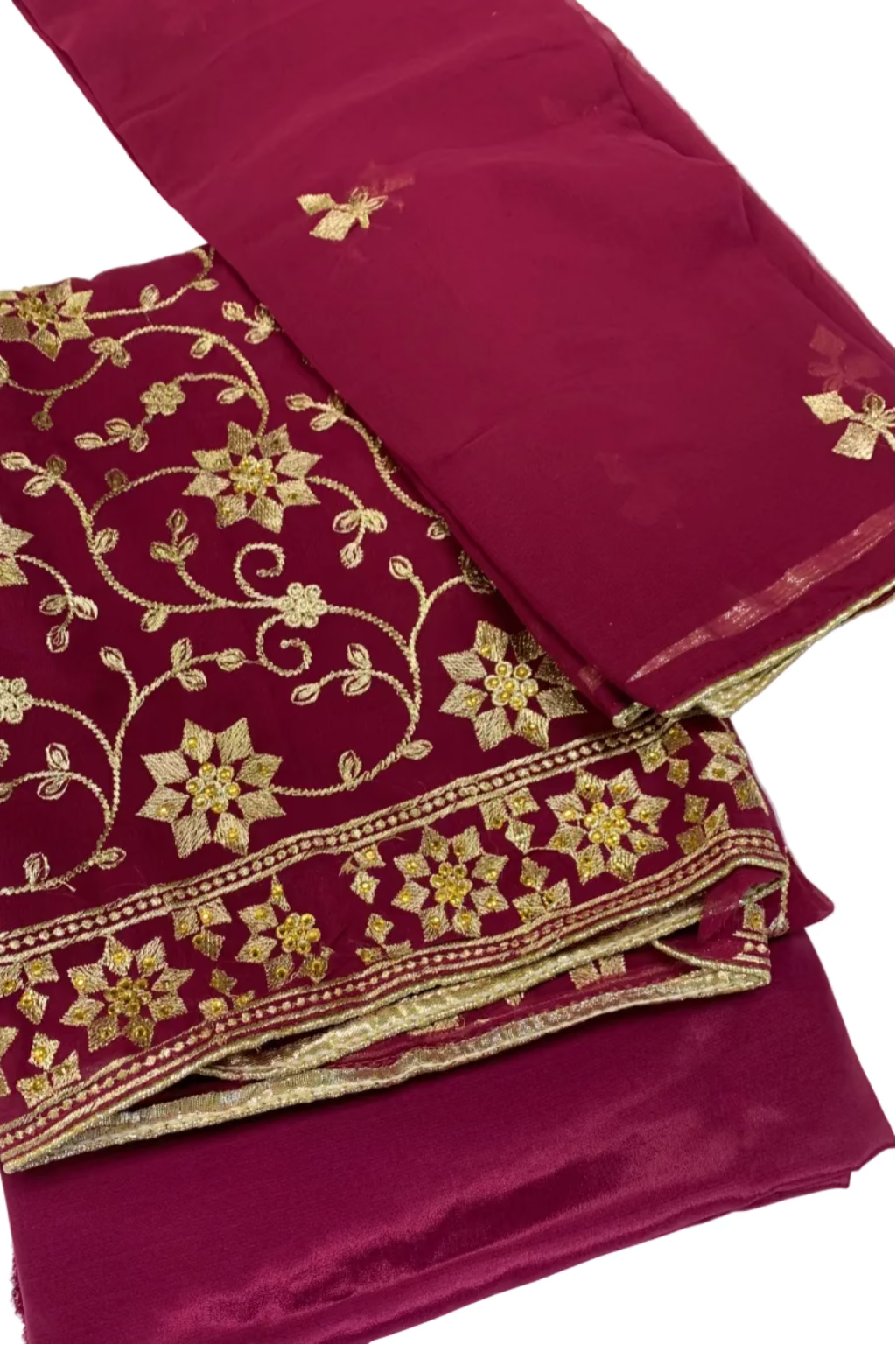 Pink fabric with gold floral embroidery on a white background
