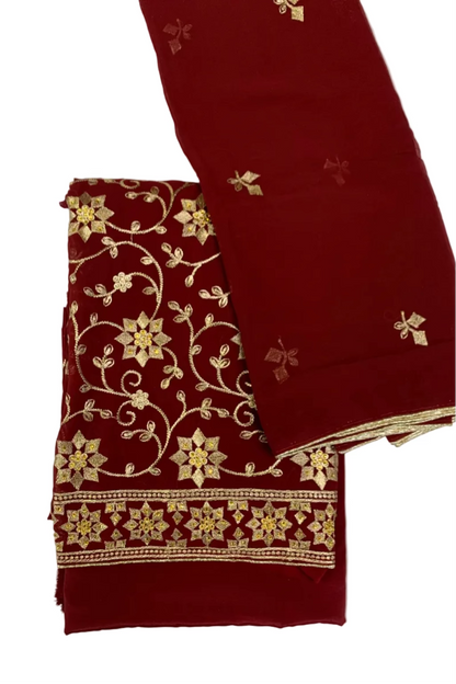 Maroon fabric with gold embroidery on a white background
