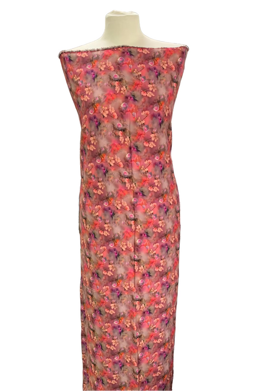 Floral patterned dress on a mannequin against a white background