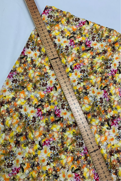 Floral fabric with a ruler for scale on a white background