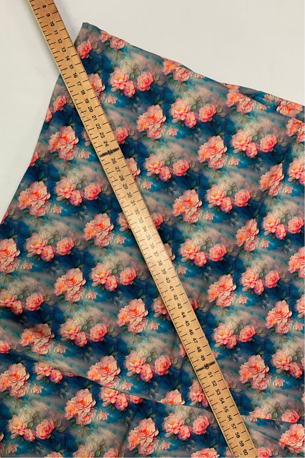 Floral patterned fabric with a ruler for scale on a white background