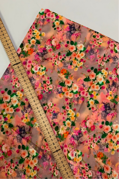 Floral-patterned viscose fabric with a ruler for scale on a white background