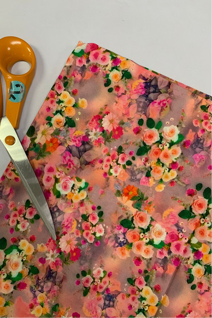 Floral fabric with a pair of scissors on a white background
