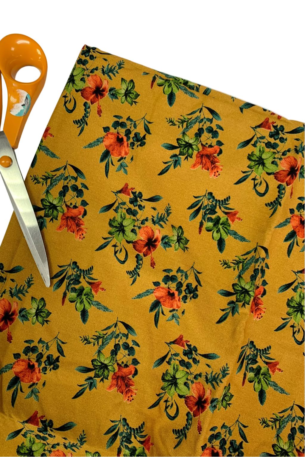 Floral fabric with orange scissors on a white background