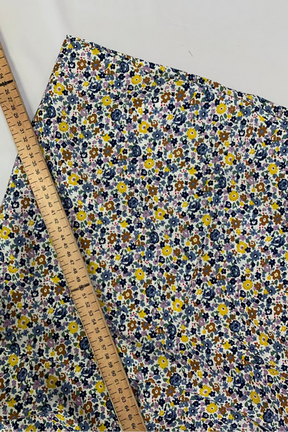 Floral fabric with a ruler for scale on a white background