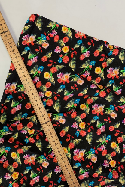 Floral fabric with a ruler for scale on a white background