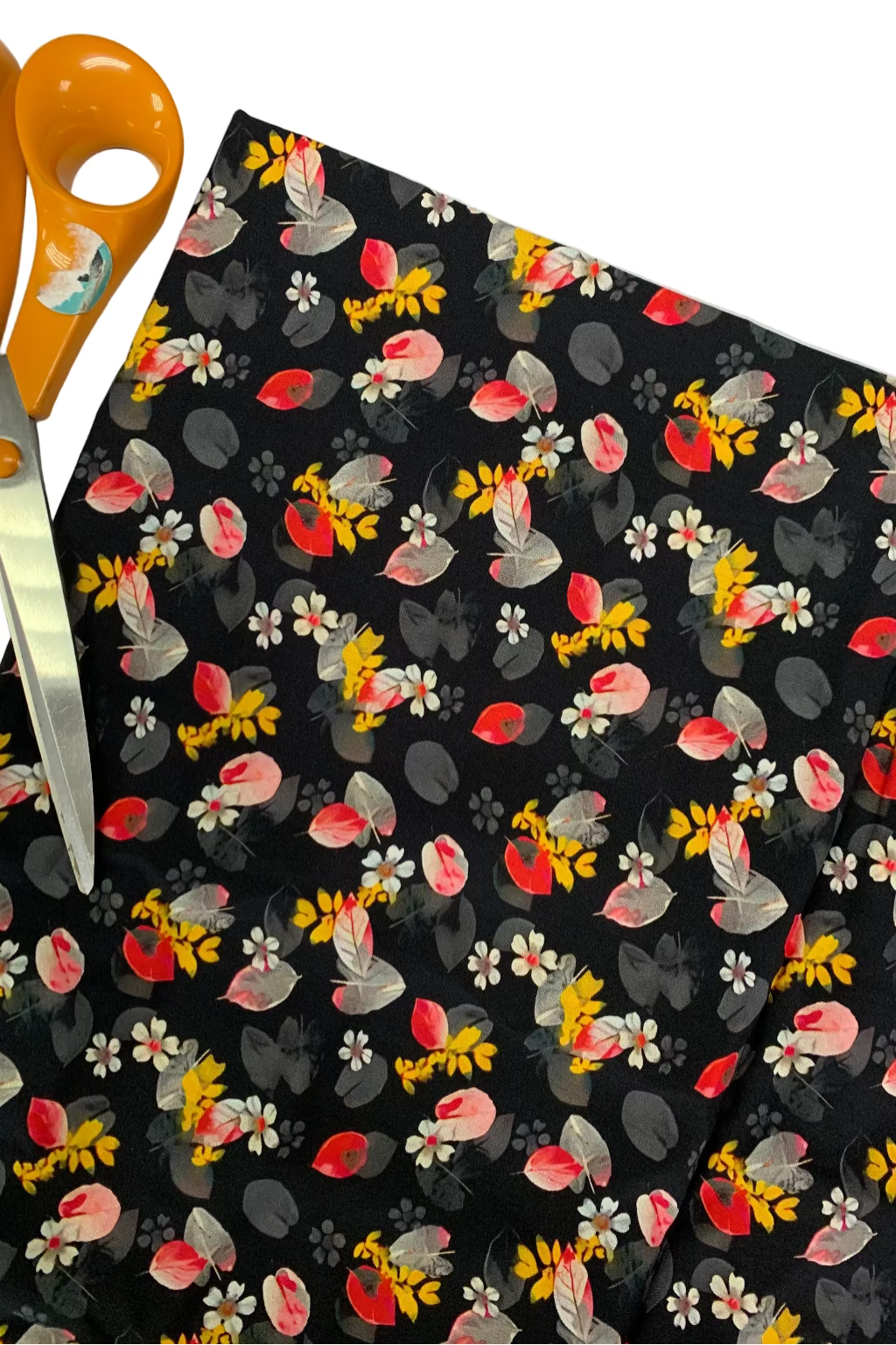 Floral-patterned fabric with scissors on a white background