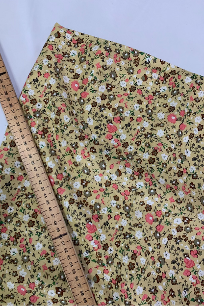 Floral fabric with a ruler for scale on a white background