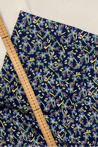 Floral-patterned fabric with a ruler for scale on a light background