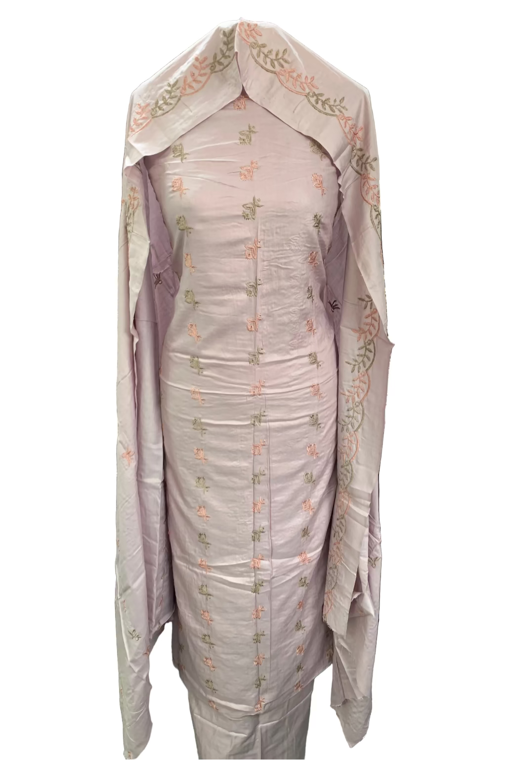 Light pink traditional outfit with floral patterns displayed in a fabric store.