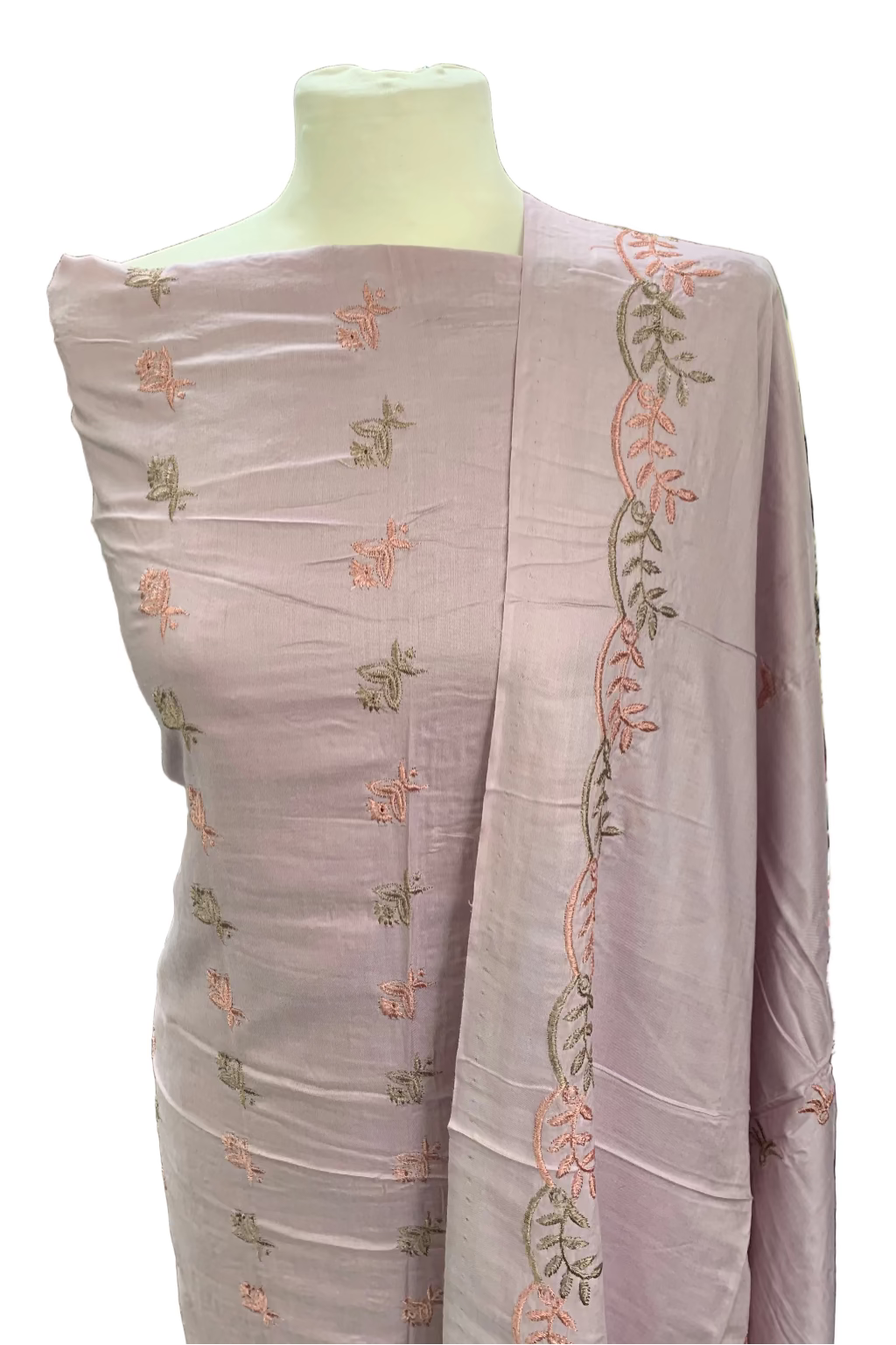 Light pink fabric with floral embroidery on a mannequin in a store setting