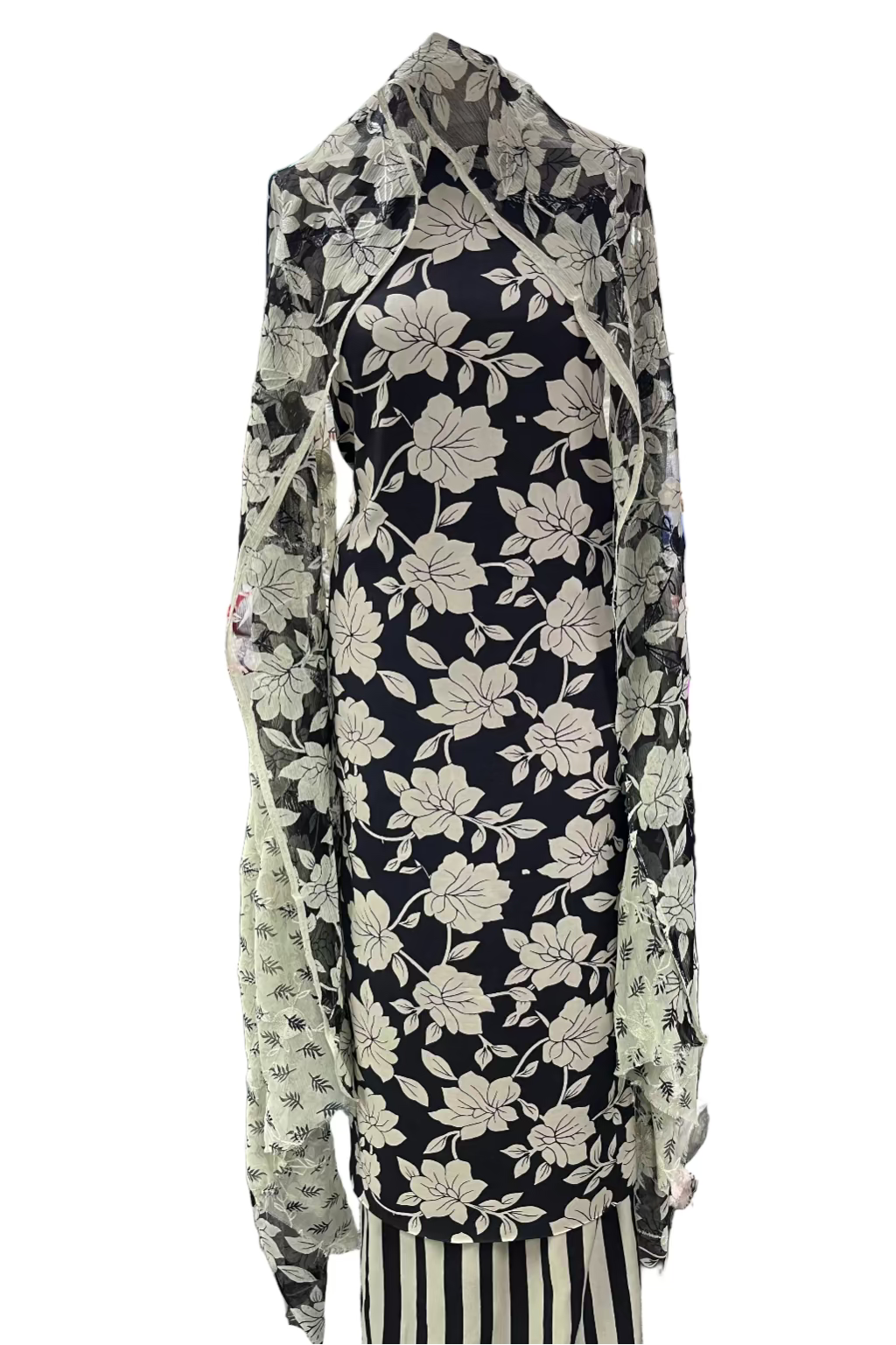 Black floral dress with striped skirt on a rack in a store setting