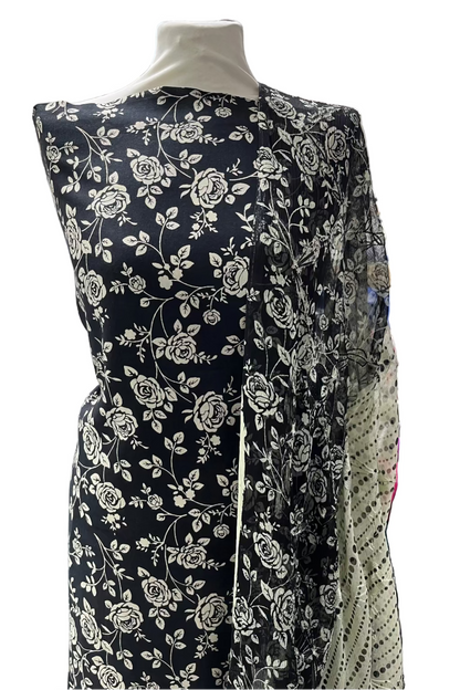 Black floral dress on a mannequin in a store setting.
