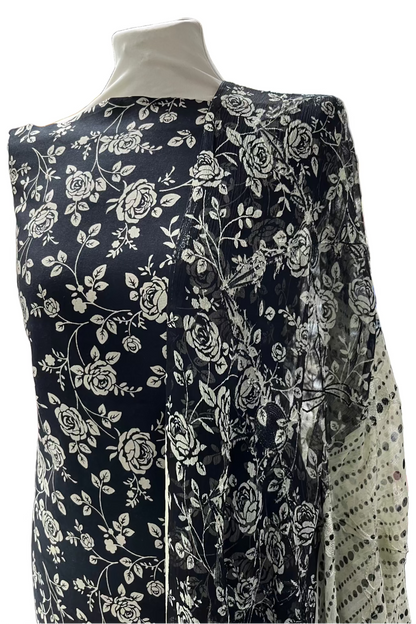 Black floral-patterned fabric on a mannequin in a store setting
