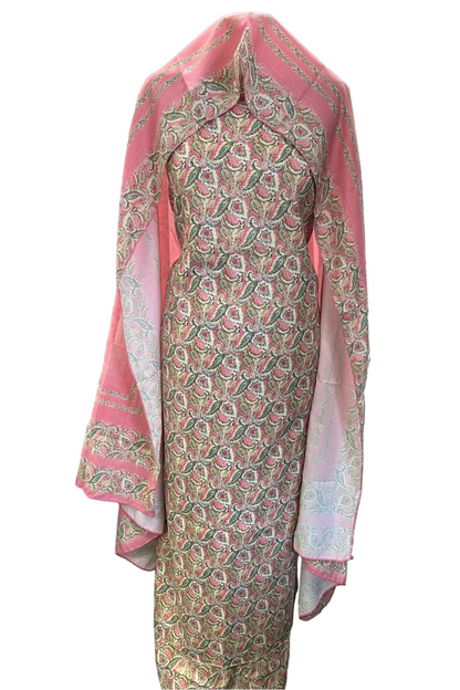 Traditional outfit with a patterned dress and pink dupatta in a store setting