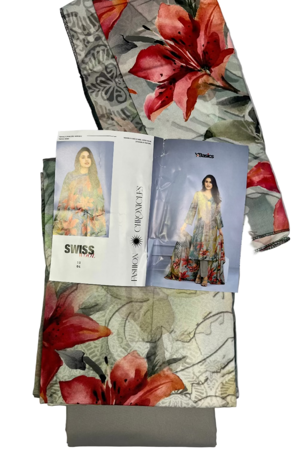 Floral fabric with a magazine or catalog on top, on a light gray background