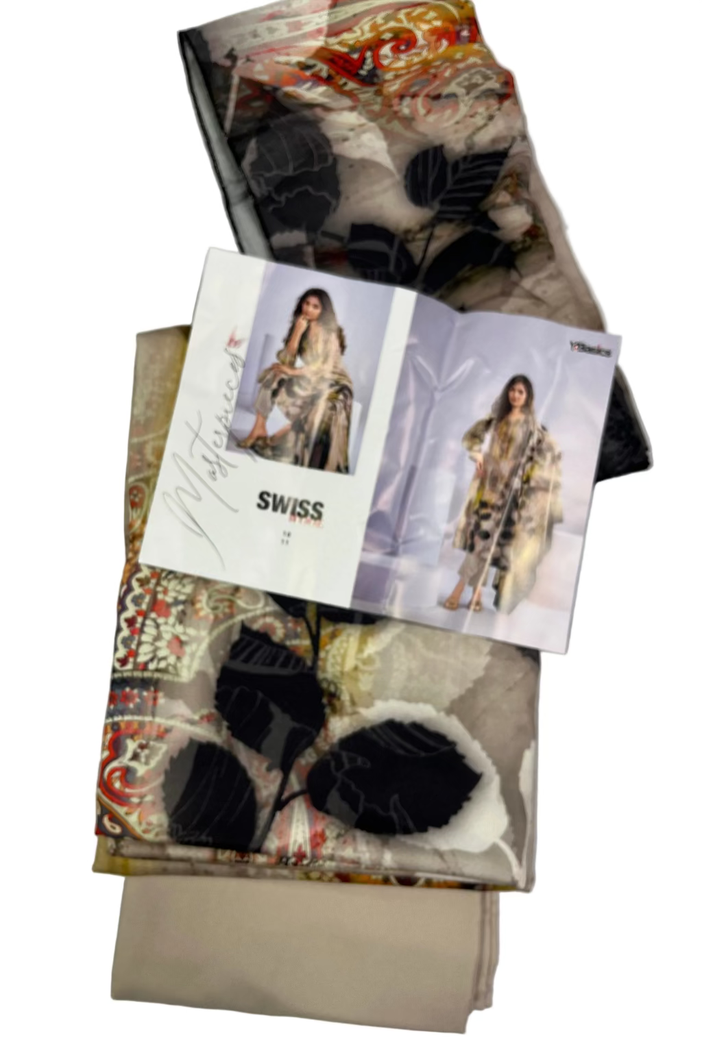 Folded fabric and a fashion magazine on a light gray background