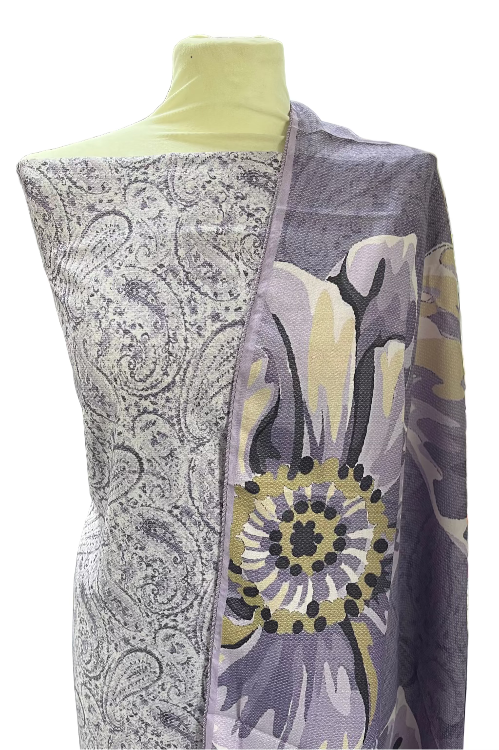 Mannequin wearing a patterned scarf in a store setting